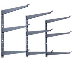 three metal shelvings with four shelves on each side and one shelf attached to the wall