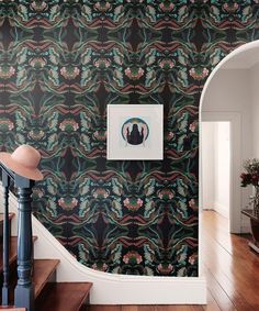 an ornate wallpapered staircase in a home