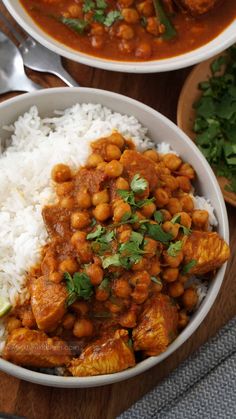 two bowls filled with rice and chickpeas on top of a wooden cutting board