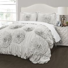 the comforter is white and has flowers on it