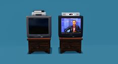 two small televisions sitting next to each other on top of wooden drawers and one is turned on