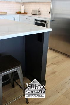 a kitchen island with two stools next to it