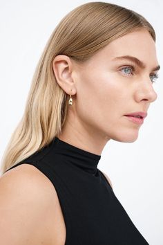 Modernism and minimalism collide in our Venus Drop Earrings. With a sleek profile and a reflective finish reminiscent of brilliant city lights, these sterling silver drop earrings are handcrafted to make your style shine day after day, night after night, season after season. Each pair includes a Marcella-branded vegan leather travel case for safe storage and easy travel.[SPLIT] Available in one size. Approximately .75” (2 cm) long. 18KT yellow gold plated brass. In silver, rhodium plated brass. Swim Jewelry, Tunic Hoodie, Sterling Silver Drop Earrings, Safe Storage, Easy Travel, Day Night, Silver Drop Earrings, Leather Travel, Gold Drop Earrings