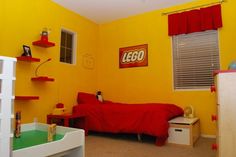 a bedroom with yellow walls and red bedding