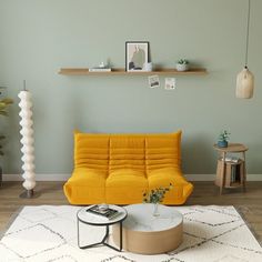 a living room with a yellow couch and coffee table on the rug in front of it