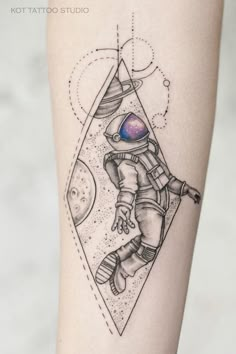 an astronaut tattoo on the leg