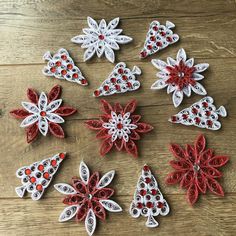 several red and white christmas decorations on a wooden table