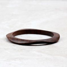 a wooden ring sitting on top of a white surface