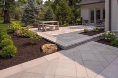 a patio with steps leading to a picnic table