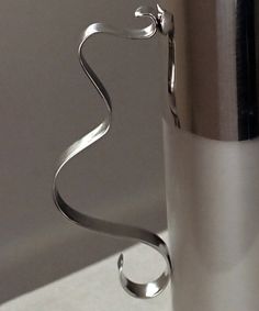 a stainless steel cup sitting on top of a counter