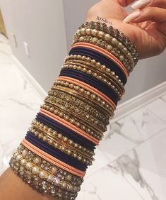 a woman's arm with several bracelets on it