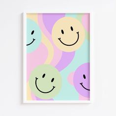 a framed art print with smiley faces on it's sides, in pastel colors