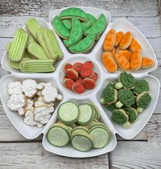 a white plate topped with lots of different types of cookies next to other food items