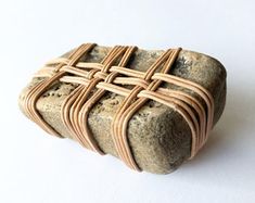 a piece of stone with woven wire around it