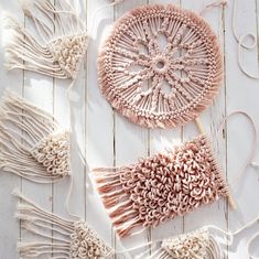 two crocheted lollipops are sitting on a white wooden surface with yarn