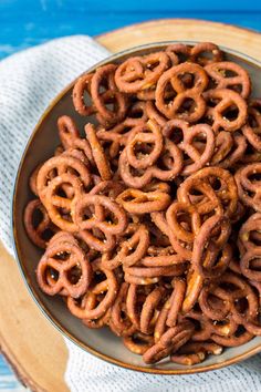 a bowl filled with pretzels sitting on top of a table