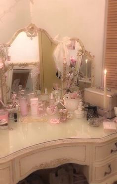 a vanity with candles and other items on it