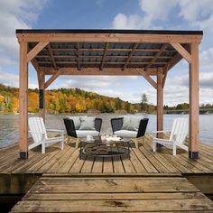 a wooden dock with chairs and a couch on it