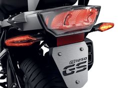 a close up of the tail light on a motorbike that is parked in front of a white background