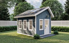 a small blue and white shed sitting in the grass