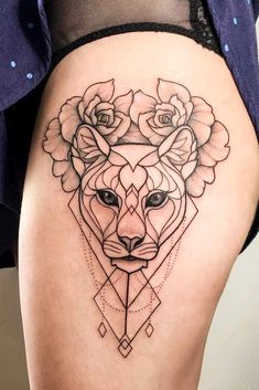 a woman's thigh with a geometric tattoo design on her leg and the image of a wolf