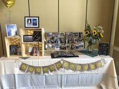 the table is set up with pictures and decorations