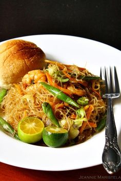 a white plate topped with food next to a fork