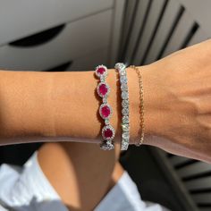 18kt White Gold Ruby Diamond Halo Bracelet: 12.77cts of oval cut rubies Surrounded and separated by 4.08cts of round diamonds Length: 7" Ruby And Diamond Bracelet, Halo Bracelet, Ruby Bangles, Round Diamond Setting, Ruby Bracelet, White Gold Bracelet, Diamond Bangle, Ruby Diamond, Diamond Halo