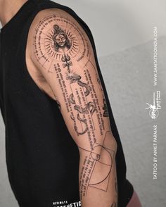 a man with a tattoo on his arm that has words and symbols all over it