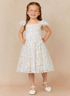 Delia is our adorable flower girl dress crafted from tulle and lace. She features a straight neckline with gathered sleeves. The look is complete with a knee length A-line skirt and a bow tie back. Delia Flower, Champagne Flower Girl, Formal Wedding Guests, White Champagne, White Flower Girl Dresses, Flower Girl Dress Lace, Flower Girl Dresses Tulle, Bridal Party Dresses