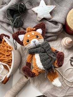 a crocheted stuffed animal sitting on top of a table next to other items