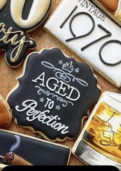 decorated cookies with the words aged to perfection written in black and gold on them, along with an image of a ship