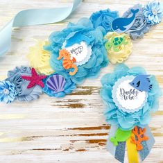 two blue and yellow flower hair clips with sea creatures on them