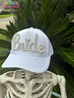 Make a sparkling statement at your bachelorette party or wedding events with this eye-catching rhinestone pearl "Bride" trucker hat! Features: - Classic trucker hat style with mesh back for breathability - Foam front panel with pearl Bride patch secured on front - Adjustable snapback for a perfect fit - Color: White front panel with white mesh back -other colors available upon request Perfect for: - Bachelorette parties - Bridal showers - Wedding day getting-ready photos - Honeymoon travel Celebrate your journey from Miss to Mrs in style! This hat is a fun and fashionable way to let everyone know you're the bride-to-be. It's also a great photo prop for those candid bachelorette party shots or casual honeymoon selfies. Care Instructions: Hand wash only. Do not machine wash or dry. Avoid sub Bride Trucker Hat With Patches, Honeymoon Selfies, Bachelorette Party Shots, Party Shots, Miss To Mrs, Pearl Bride, Bridal Accessory, From Miss To Mrs, Richmond Hill