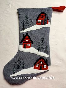 a christmas stocking with houses and trees on it