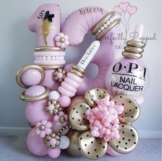 pink and gold items are arranged in the shape of an elephant, with balloons attached to it