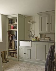 an image of a kitchen with boots on the shelves