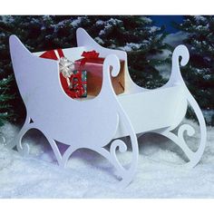 a white sleigh with presents in it sitting in the snow