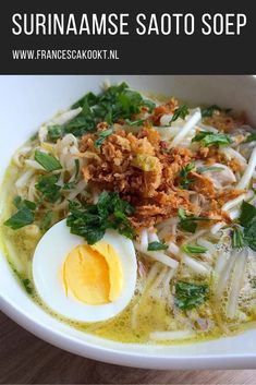 an image of a bowl of food with noodles and eggs in it on the table