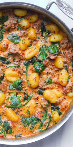 Creamy Sausage Gnocchi with Spinach and Tomato Sauce in a stainless steel pan Gnocchi With Tomato Cream Sauce, Gnocchi Tomato Cream Sauce, Jamie Oliver Recipes 30 Minute Meals, Tuscan Sausage Gnocchi, Creamy Sausage Gnocchi, Gnocchi With Spinach, Tuscan Sausage, Sausage Gnocchi, Pasta Sausage