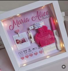 there is a pink hat and other items in the shadow box that are on display