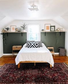 a bed sitting on top of a wooden floor next to a window in a bedroom