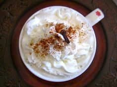 a cup with whipped cream and cinnamon sprinkles