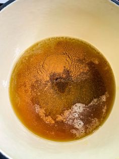 a bowl filled with brown liquid on top of a table