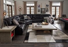 a living room filled with furniture and a pool table