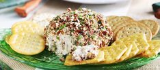 a plate with crackers, crackers and cheese ball on it