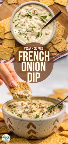 a bowl of french onion dip with crackers on the side and a hand dipping it in