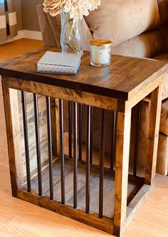 a wooden table with a vase on top of it next to a brown leather couch