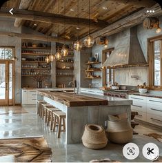 a large kitchen with lots of counter space and lights hanging from the ceiling above it