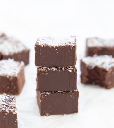 several pieces of brownie sitting on top of each other with powdered sugar on top